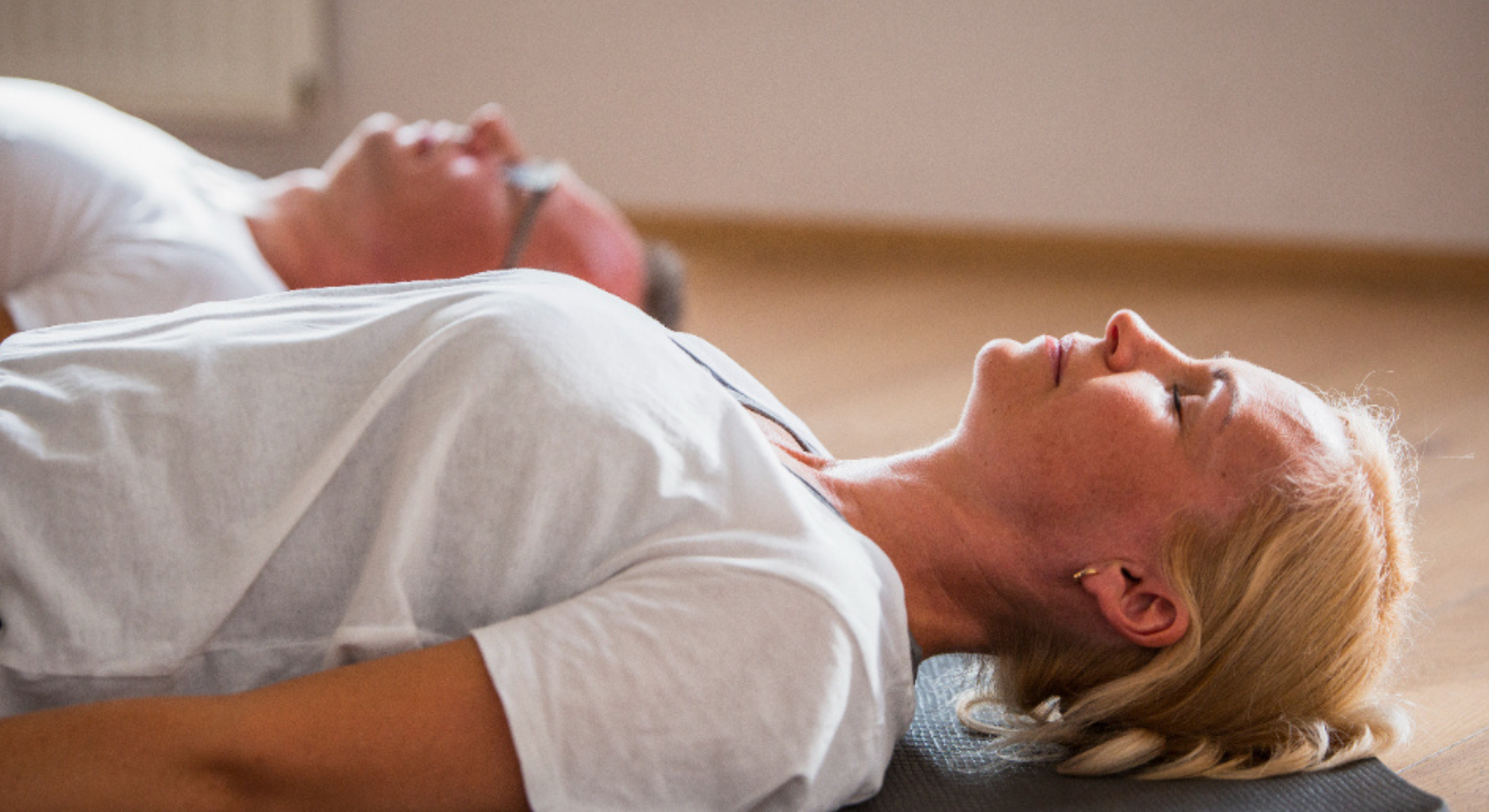 Person practicing mindful breathing in a calm professional coaching environment